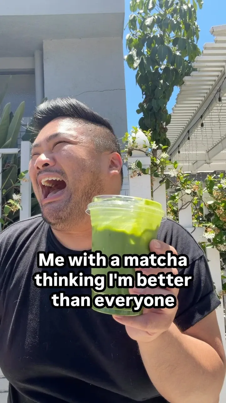 I hold a cup of matcha beneath text about thinking I am better than everyone.