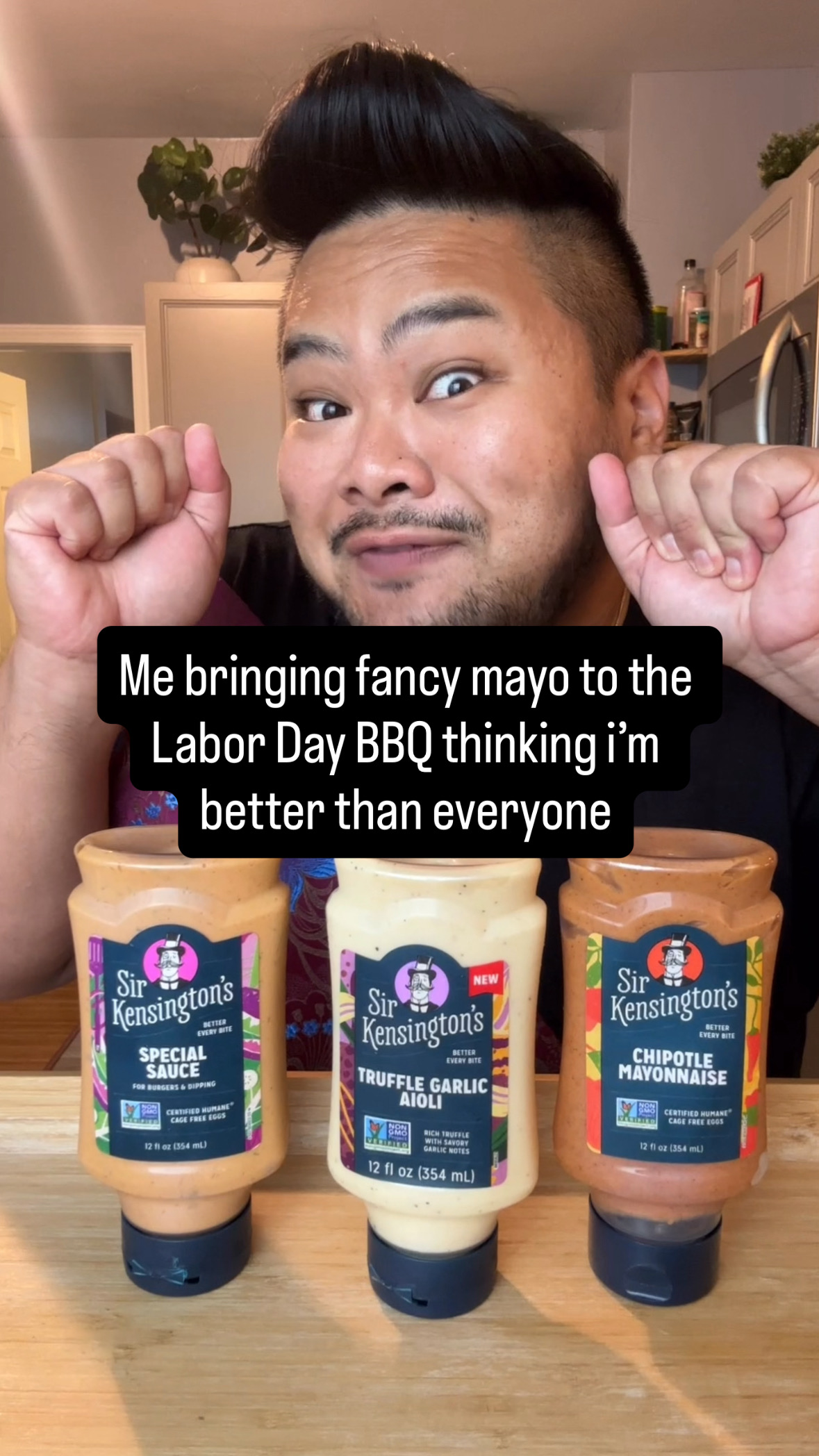 I pose behind bottles of Sir Kensington’s Special Sauce, Truffle Garlic Aioli, and Chipotle Mayonnaise beneath the Labor Day BBQ premise.