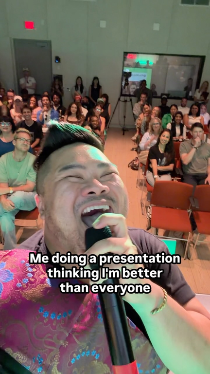 I’m smiling with a microphone in front of the Camp Edits audience.