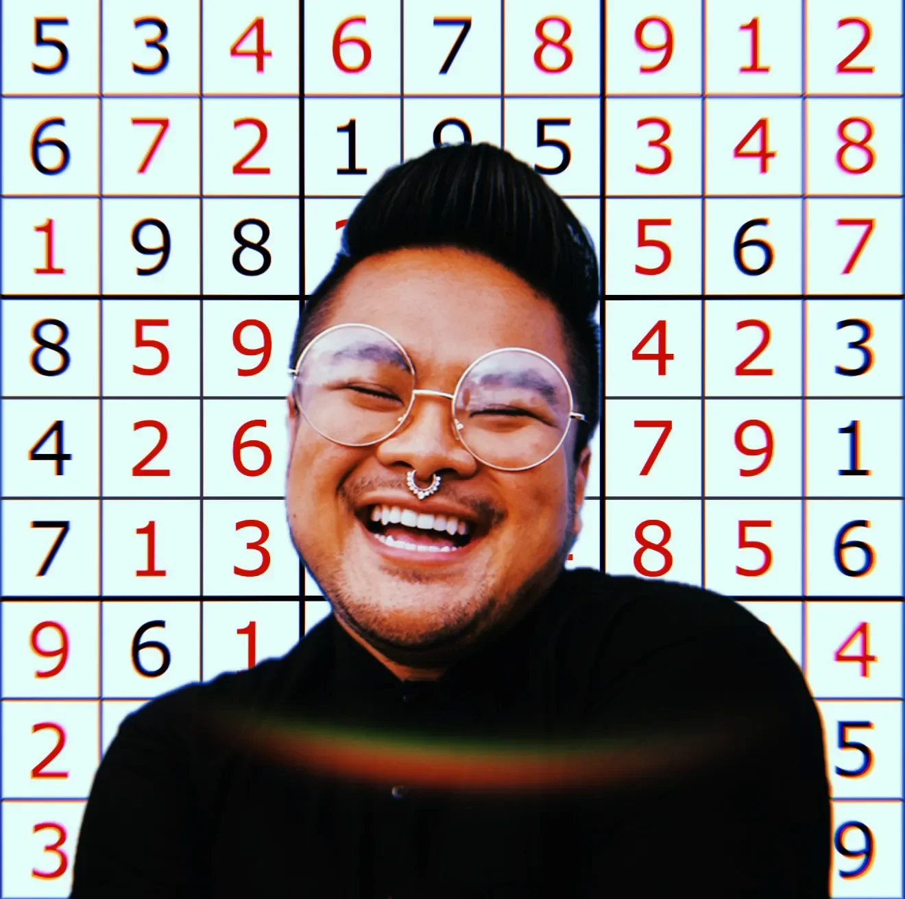 RV Mendoza smiles in front of a grid filled with red and black numbers.