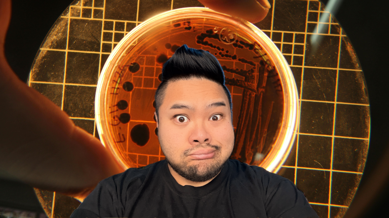 RV Mendoza looks surprised in front of a magnified laboratory culture dish.