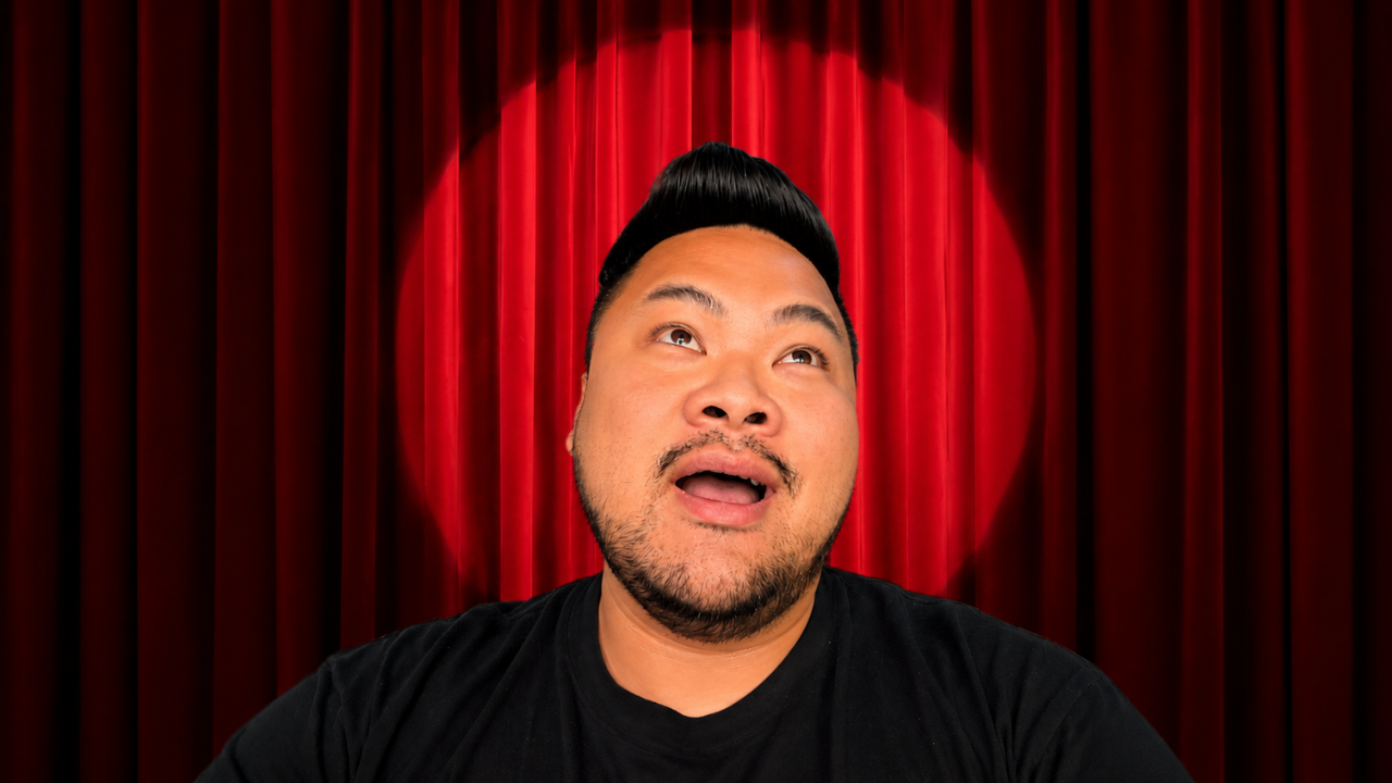 RV Mendoza standing in front of a red stage curtain