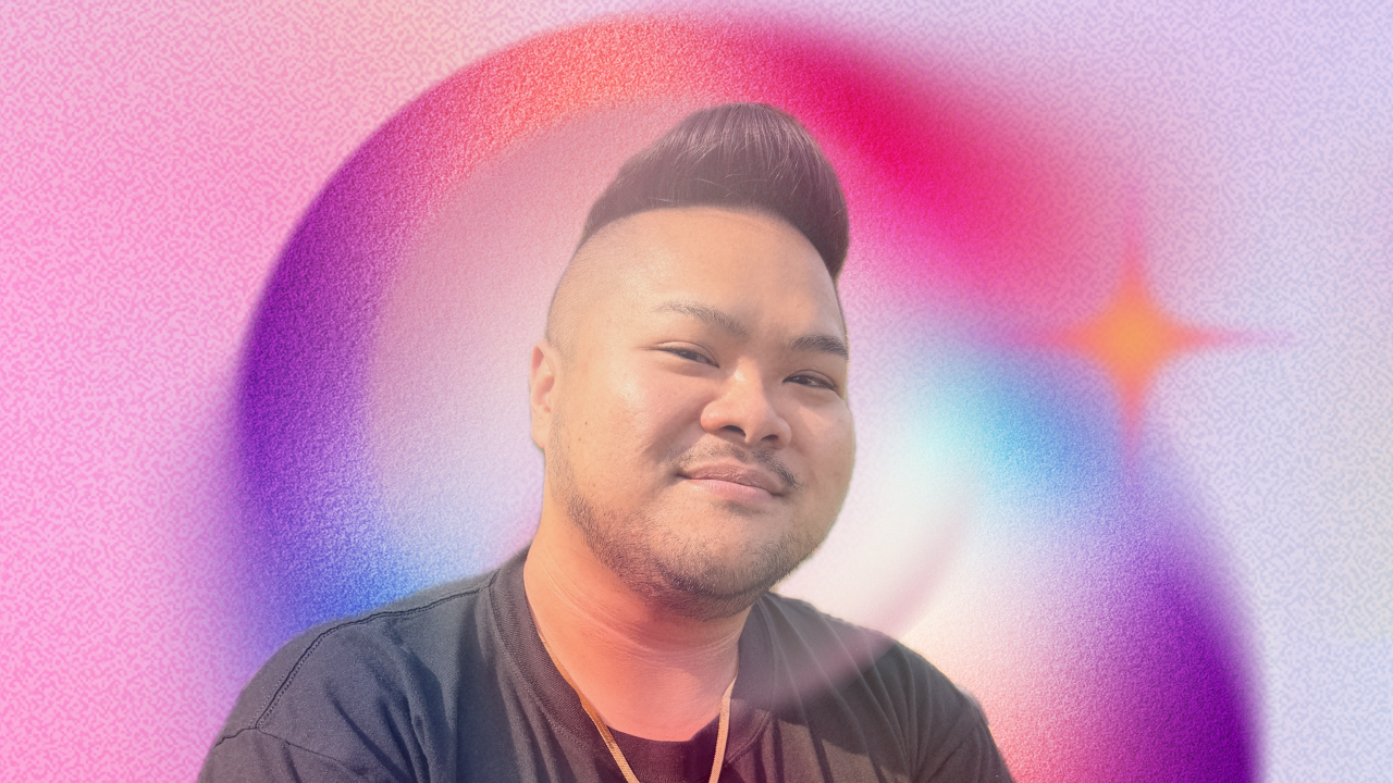 RV Mendoza smiling against a soft pink, purple, and blue galactic background.