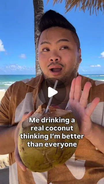 RV Mendoza holding a coconut on a beach in the Dominican Republic